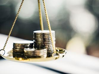 coins on old fashioned scales